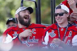 Washington Capitals forward Alex Ovechkin (8), of Russia, left, laughs as he sits next to teammate, forward Nicklas Backstrom (19), of Sweden, right, while on stage during the Stanley Cup victory celebration on the National Mall in Washington, Tuesday, June 12, 2018. (AP Photo/Pablo Martinez Monsivais)