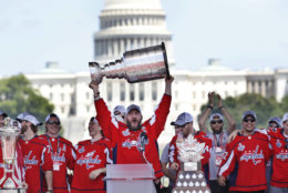 Washington Capitals' Alex Ovechkin, of Russia, holds up the Stanley Cup trophy during the NHL hockey team's Stanley Cup victory celebration, Tuesday, June 12, 2018, at the National Mall in Washington. The U.S. Capitol rises in the background. (AP Photo/Jacquelyn Martin)