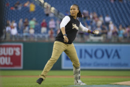 Capitol Hill Police Special Agent Crystal Griner throws out the first pitch to start the 57th Congressional Baseball Game at National's Park in Washington, Thursday, June 14, 2018. On June 14, 2017, Congressional members were victims of a shooting at the baseball field they were practicing on in Alexandria, Va. (AP Photo/Cliff Owen)