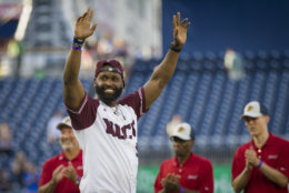 Capitol Police Special Agent David Bailey celebrates after throwing out the first pitch to start the 57th Congressional Baseball Game at National's Park in Washington, Thursday, June 14, 2018. On June 14, 2017, Congressional members were victims of a shooting at the baseball field they were practicing on in Alexandria, Va. (AP Photo/Cliff Owen)