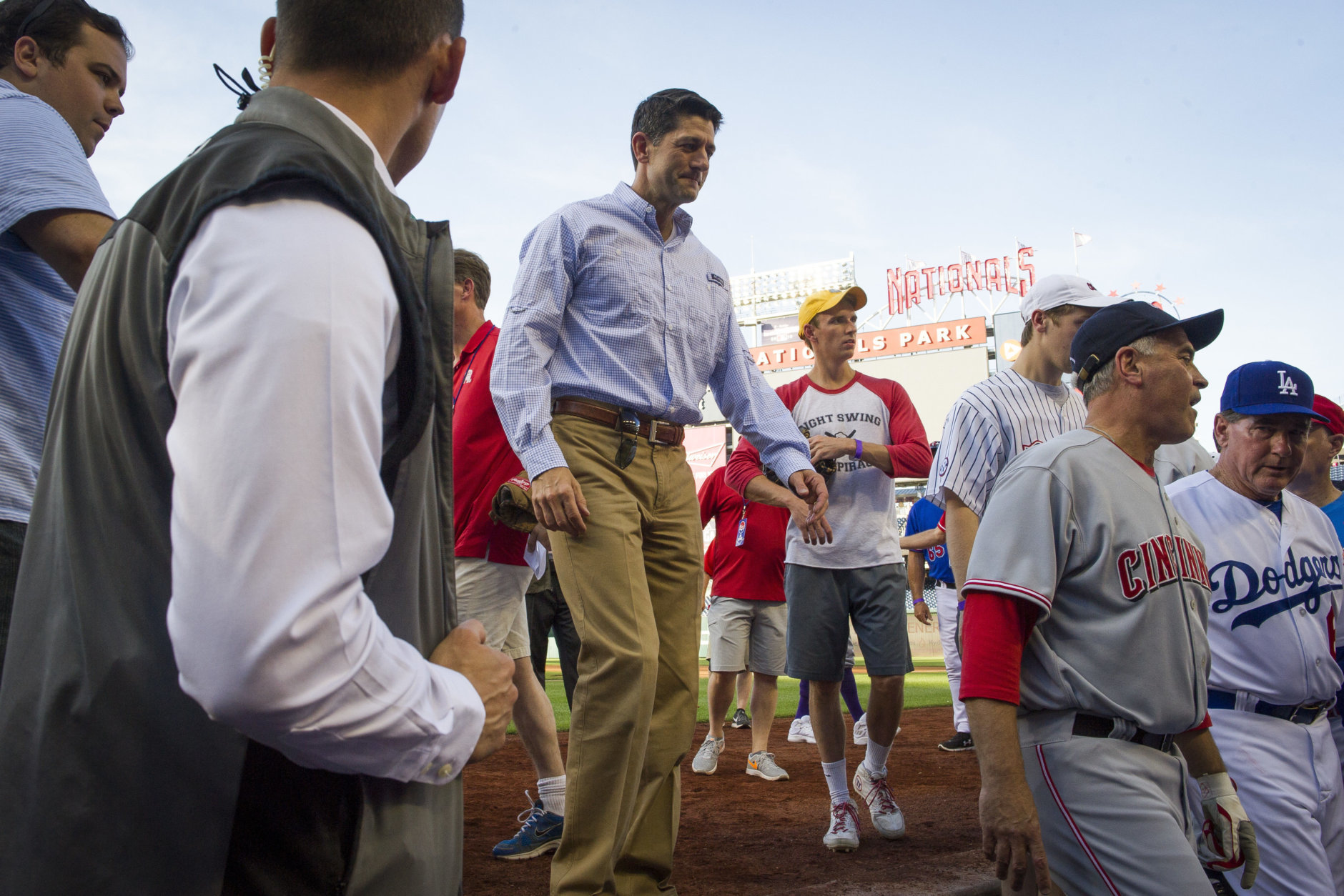 Speaker of the House Paul Ryan, of Wisconsin, walks into the Republican team dugout at the start of the 57th Congressional Baseball Game at National's Park in Washington, Thursday, June 14, 2018. On June 14, 2017, Congressional members were victims of a shooting at the baseball field they were practicing on in Alexandria, Va. (AP Photo/Cliff Owen)