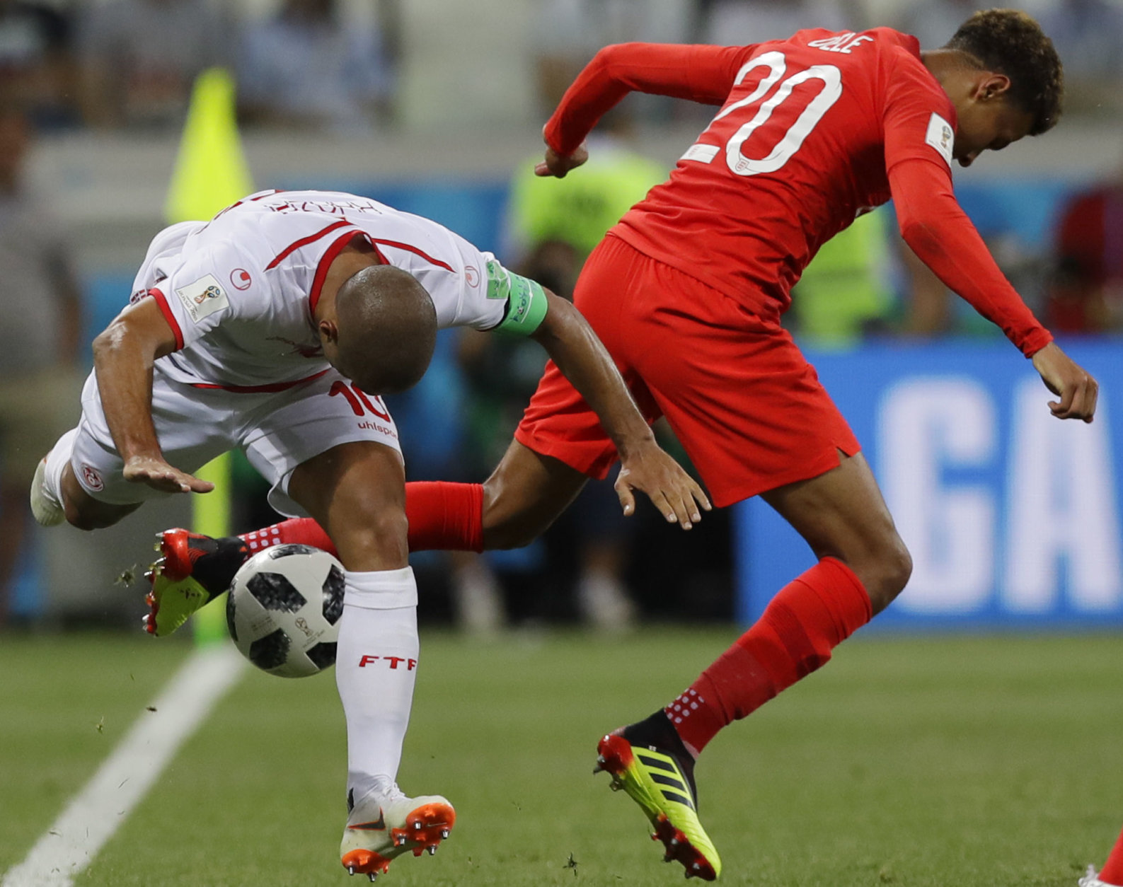 Tunisia's captain Wahbi Khazri, left, and England's Dele Alli compete for the ball during a group G match at the 2018 soccer World Cup in the Volgograd Arena in Volgograd, Russia, Monday, June 18, 2018. (AP Photo/Alastair Grant)