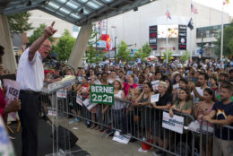 Sen. Bernie Sanders, I-Vt., accompanied by Democrat Ben Jealous speaks to the crowd during a gubernatorial campaign rally in Maryland's Democratic primary in downtown Silver Spring, Md., Monday, June 18, 2018. Sanders may not be endorsing his own son's congressional bid, but he rallied on a hot Monday night in Maryland to fire up voters for Jealous' campaign for governor. (AP Photo/Jose Luis Magana)