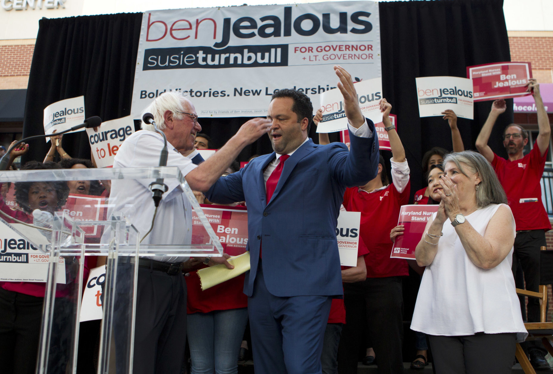 Sen. Bernie Sanders, I-Vt., greets Maryland Democratic gubernatorial candidate Ben Jealous as running mate Susie Turnbull looks on during a campaign rally in Maryland's Democratic primary in downtown Silver Spring, Md., Monday, June 18, 2018. (AP Photo/Jose Luis Magana)