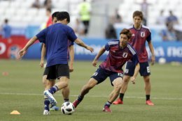 Japanese players warm up ahead of the group H match between Japan and Poland at the 2018 soccer World Cup at the Volgograd Arena in Volgograd, Russia, Thursday, June 28, 2018. (AP Photo/Andrew Medichini)