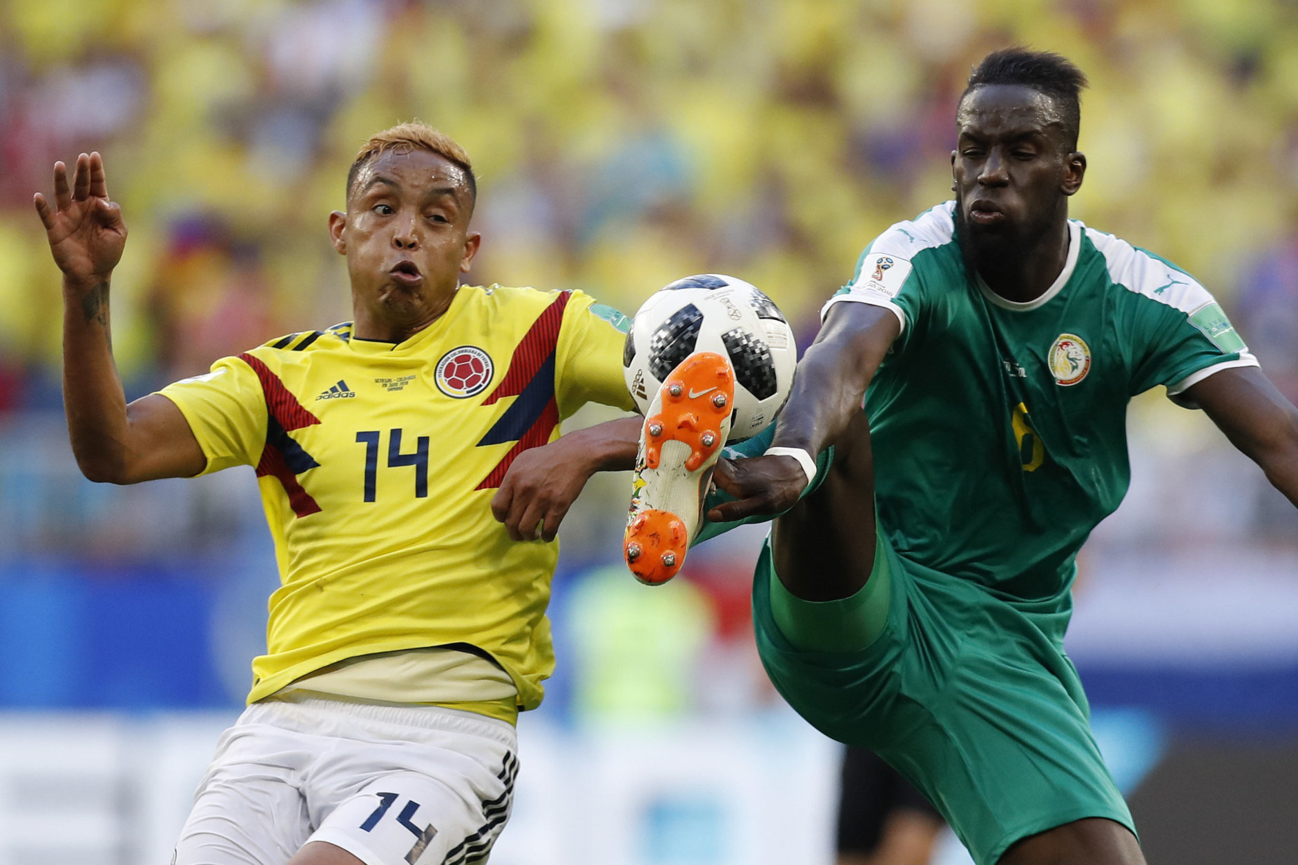 Colombia's Luis Muriel, left, and Senegal's Salif Sane challenge for the ball during the group H match between Senegal and Colombia, at the 2018 soccer World Cup in the Samara Arena in Samara, Russia, Thursday, June 28, 2018. (AP Photo/Efrem Lukatsky)