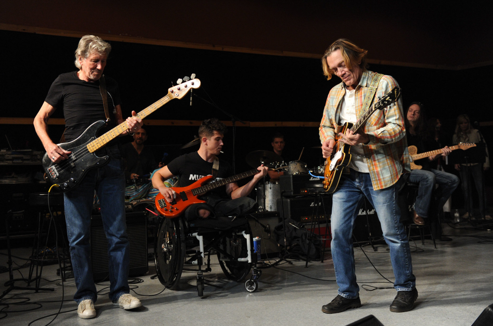 Musician Roger Waters, left, and his band member guitarist G.E. Smith, right, hold rehearsals with members of the Wounded Warriors Project, including Marine Corporal Marcus Dandre, for the "Stand Up For Heroes" benefit concert presented by the New York Comedy Festival &amp; the Bob Woodruff Foundation at S.I.R. Studios on Monday, Nov. 4, 2013, in New York. (Photo by Evan Agostini/Invision/AP)