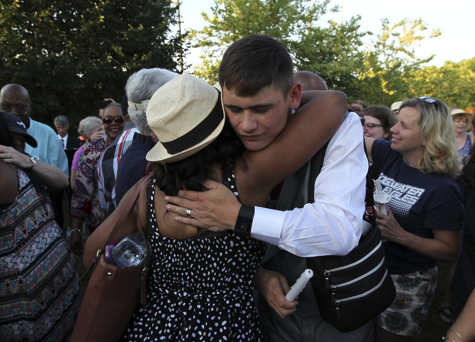 People hug during a candlelight vigil across the street from where five journalists were slain in their newsroom in Annapolis, Md., Friday, June 29, 2018. Prosecutors say Jarrod W. Ramos opened fire Thursday in the Capital Gazette newsroom. (AP Photo/Jose Luis Magana)