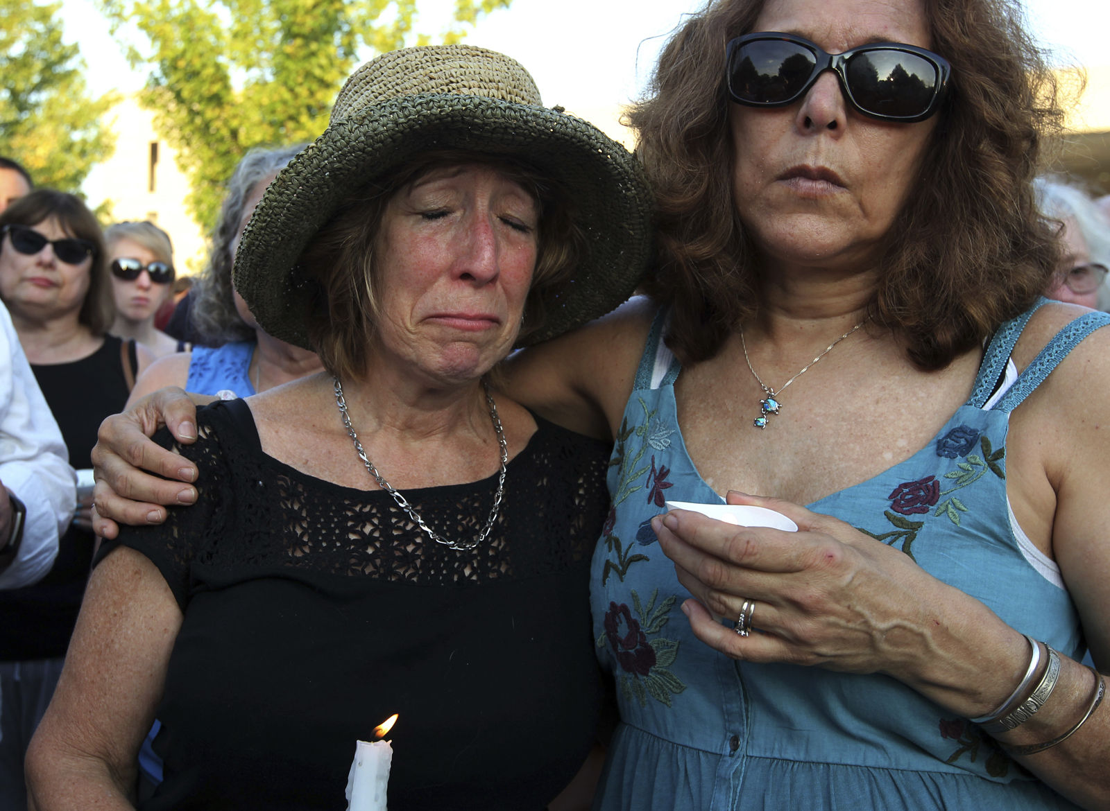 People gather for a candlelight vigil across the street from where five journalists were slain in their newsroom in Annapolis, Md., Friday, June 29, 2018. Prosecutors say Jarrod W. Ramos opened fire Thursday in the Capital Gazette newsroom. (AP Photo/Jose Luis Magana)