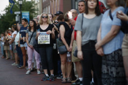 People stand in silence during a vigil in response to a shooting in the Capital Gazette newsroom Friday, June 29, 2018, in Annapolis, Md. Prosecutors say Jarrod W. Ramos opened fire Thursday in the newsroom. (AP Photo/Patrick Semansky)