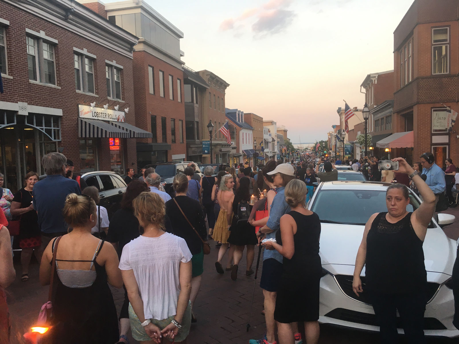 Mourners holding candles on the streets of Annapolis, Maryland, on Friday to honor those who were killed in a shooting at the Capital Gazette. (WTOP/Mike Murillo)