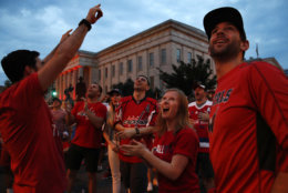 Jack Hanlon, left, of Alexandria, Va.; Allison Baden, of Alexandria; and Adam Abramson, right, of Washington, react to a goal that they thought was scored by the Washington Capitals, as they watch Game 3 of the NHL hockey Stanley Cup Final between the Washington Capitals and the Vegas Golden Knights on a large screen outside the arena Saturday, June 2, 2018, in Washington. (AP Photo/Jacquelyn Martin)