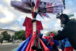 A vendor sells Caps' pennants along the parade route. (WTOP/Neal Augenstein)