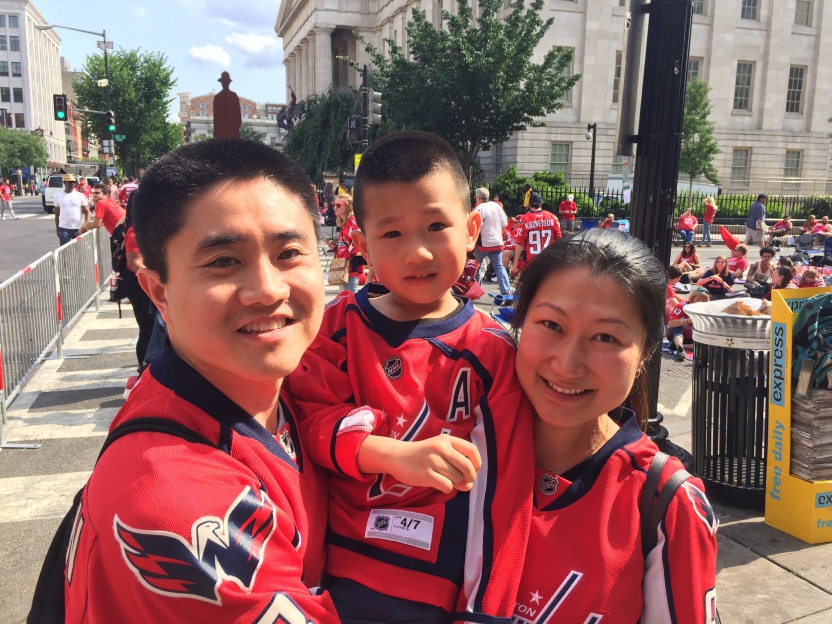 The Liang family wait for the puck to drop outside Capital One Arena on Thursday. (WTOP/Kristi King)