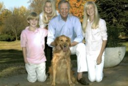 Council member Jack Evans (with family) get to discuss policy with their dog Kelly. (Courtesy Humane Rescue Alliance)