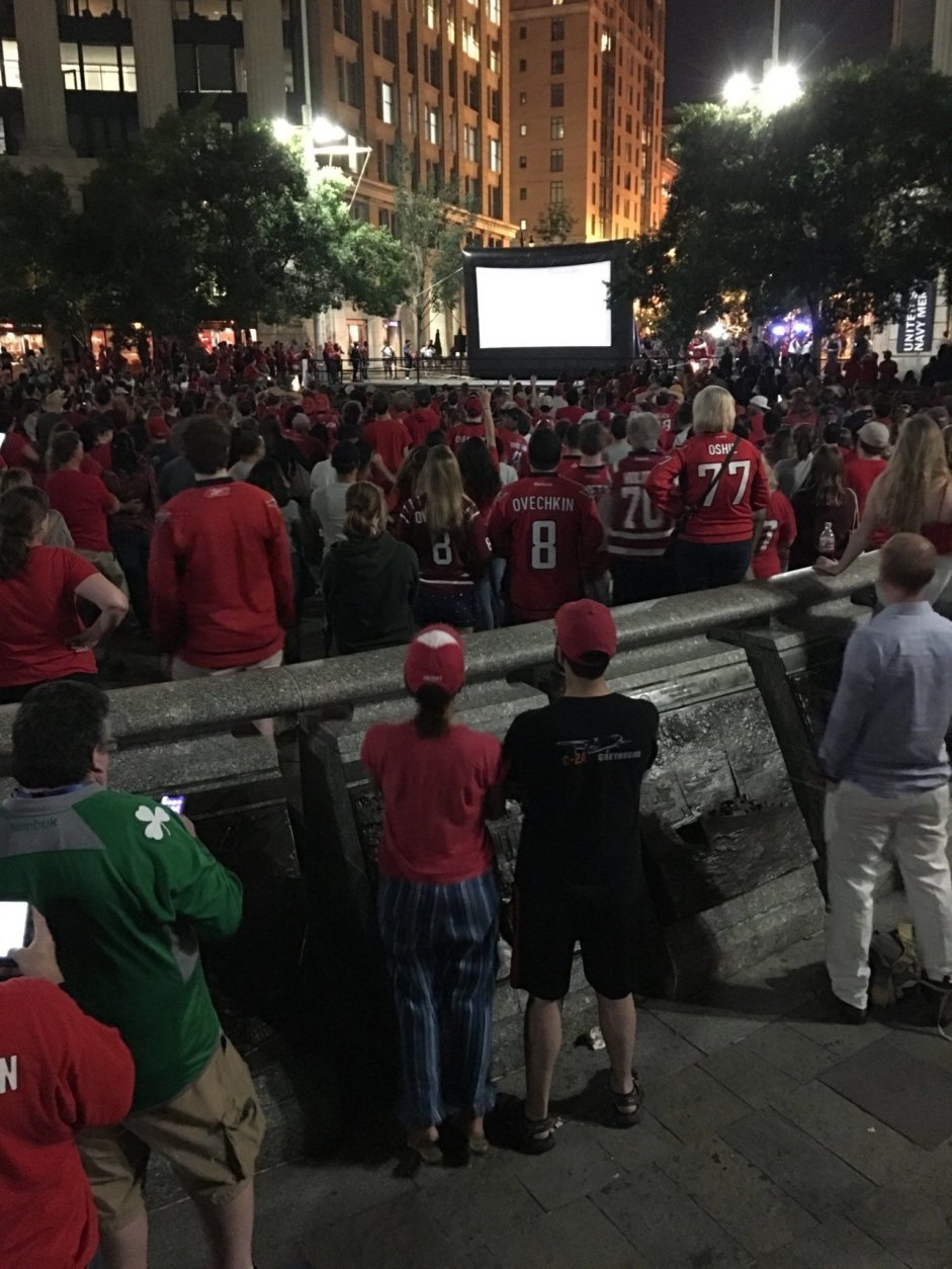 The crowd at U.S. Navy Memorial is on their feet, mesmerized, with two minutes left to go. (WTOP/Shawn Anderson)