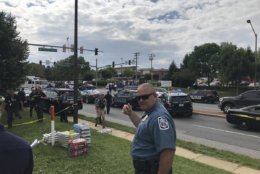 Police blocked a perimeter and held people back from the scene of an active shooting at the Capital Gazette building, 888 Bestgate Road, in Annapolis, Maryland, Thursday afternoon.  (WTOP/Michelle Basch)