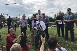 Anne Arundel County Executive Steve Schuh,  flanked by Maryland Gov. Larry Hogan (Left), speaks at a police briefing in the aftermath of an active shooting situation at the Capital Gazette building, 888 Bestgate Road, in Annapolis, Maryland, Thursday afternoon.  (WTOP/Michelle Basch)