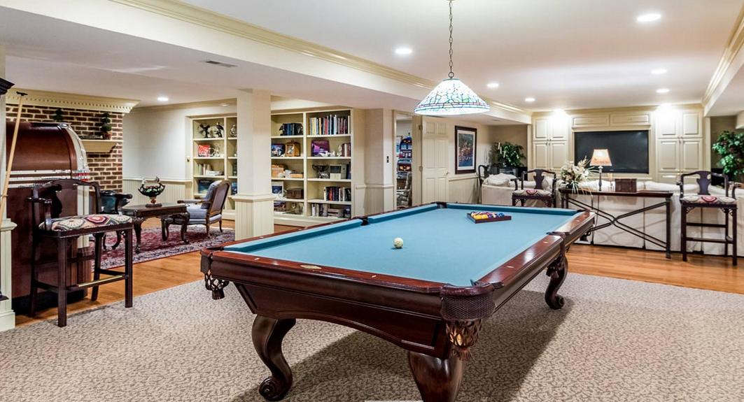 The 15,000-square-foot main house has 5 en-suite bedrooms, a foyer with duel staircases, a pub, billiards room, wine cellar, theater and sauna. (Courtesy Platinum Luxury Auctions)