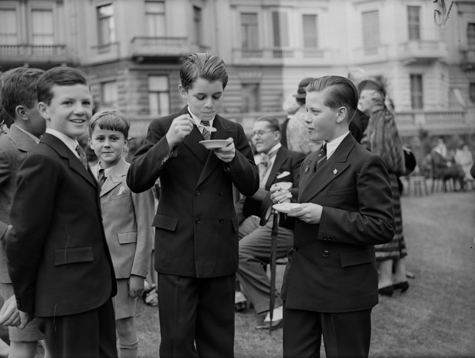 4th July 1939:  Robert Kennedy (1925-1968) ( on the left) eating ice-cream with John Sheffield in the garden of the American embassy in London during the time when his father, Joseph Kennedy was ambassador to Great Britain.  (Photo by Fox Photos/Getty Images)