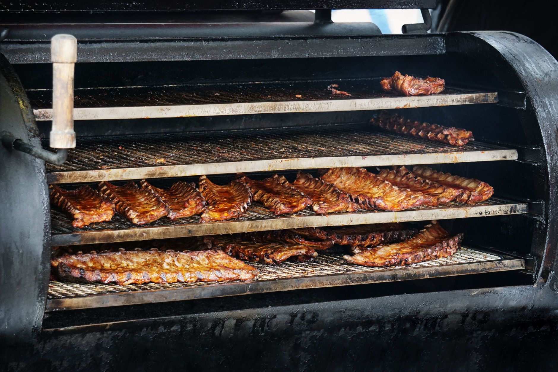 Barbecue spareribs in barbecue smoker, grilled pork meat ribs (Courtesy/Getty Images)