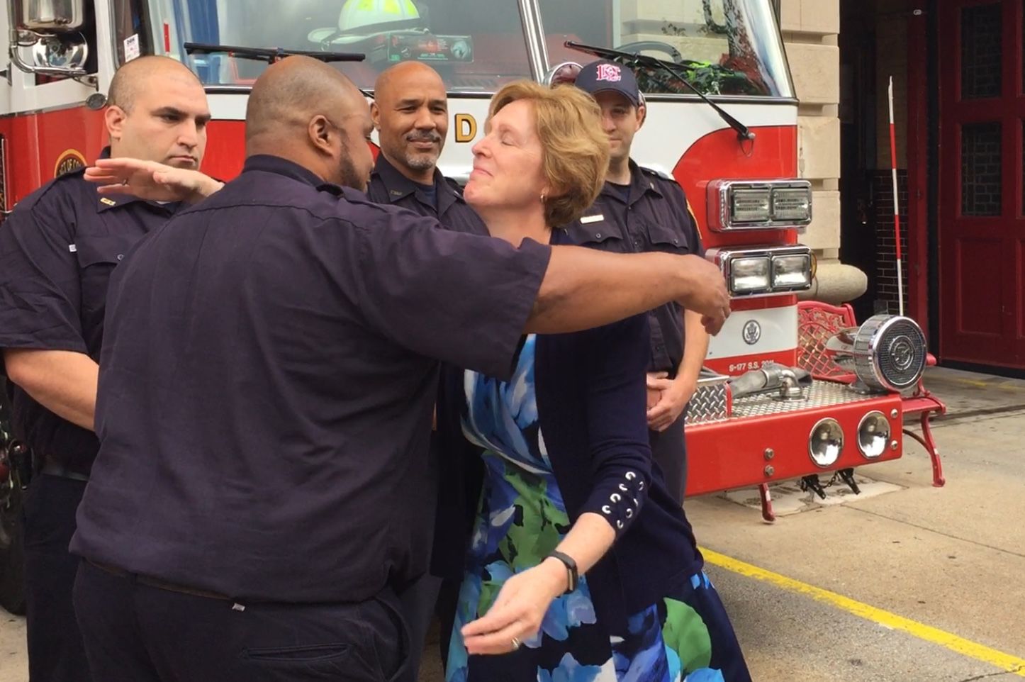 Victoria Wolf of Crofton, Maryland, thanks members of Engine Company 3 who responded when she went into cardiac arrest Aug. 14. (WTOP/Kristi King)