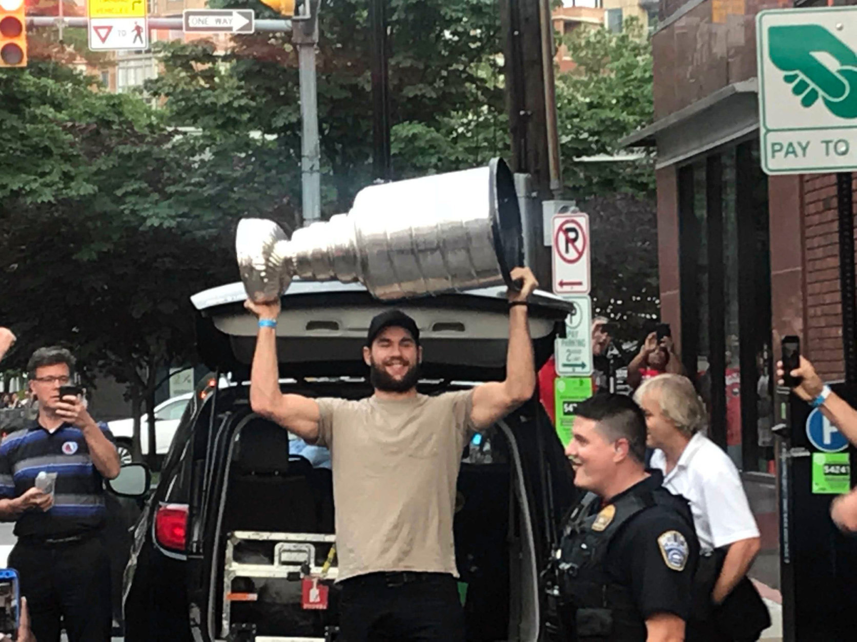 Tom Wilson hefts the Stanley Cup outside Don Tito in Clarendon. (WTOP/Chris Cichon)
