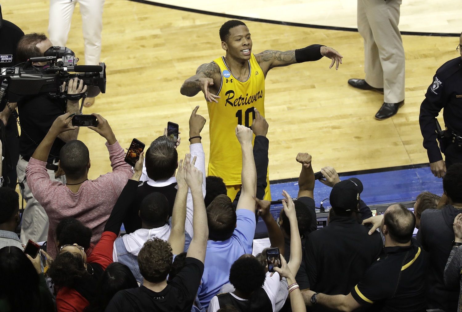 UMBC's Jairus Lyles (10) celebrates with fans after the team's 74-54 win over Virginia in a first-round game in the NCAA men's college basketball tournament in Charlotte, N.C., Friday, March 16, 2018. (AP Photo/Chuck Burton)