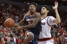 Virginia guard Nigel Johnson (23) goes in for a layup past the defense of Louisville forward Anas Mahmoud (14) during the first half of an NCAA college basketball game, Thursday, March 1, 2018, in Louisville, Ky. (AP Photo/Timothy D. Easley)