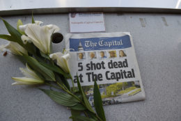 A memorial for Capital Gazette sports writer John McNamara is displayed at a seat in the press box before a baseball game between the Baltimore Orioles and the Los Angeles Angels, Friday, June 29, 2018, in Baltimore. McNamara is one of five victims in a  shooting in the newspaper's newsroom Thursday in Annapolis, Md. (AP Photo/Gail Burton)