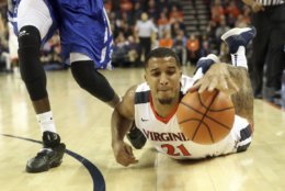 Virginia forward Isaiah Wilkins (21) reaches for a loose ball next to Hampton guard Malique Trent during an NCAA college basketball game Friday, Dec. 22, 2017, in Charlottesville, Va. (AP Photo/Andrew Shurtleff)