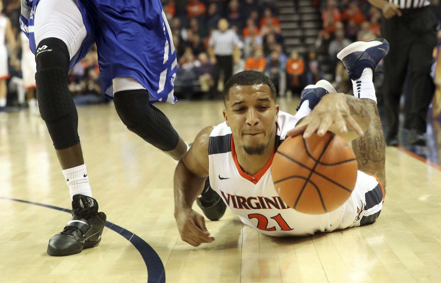 Virginia forward Isaiah Wilkins (21) reaches for a loose ball next to Hampton guard Malique Trent during an NCAA college basketball game Friday, Dec. 22, 2017, in Charlottesville, Va. (AP Photo/Andrew Shurtleff)