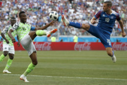 Nigeria's John Obi Mikel, left, and Iceland's Gylfi Sigurdsson compete for the ball during the group D match between Nigeria and Iceland at the 2018 soccer World Cup in the Volgograd Arena in Volgograd, Russia, Friday, June 22, 2018. (AP Photo/Darko Vojinovic)