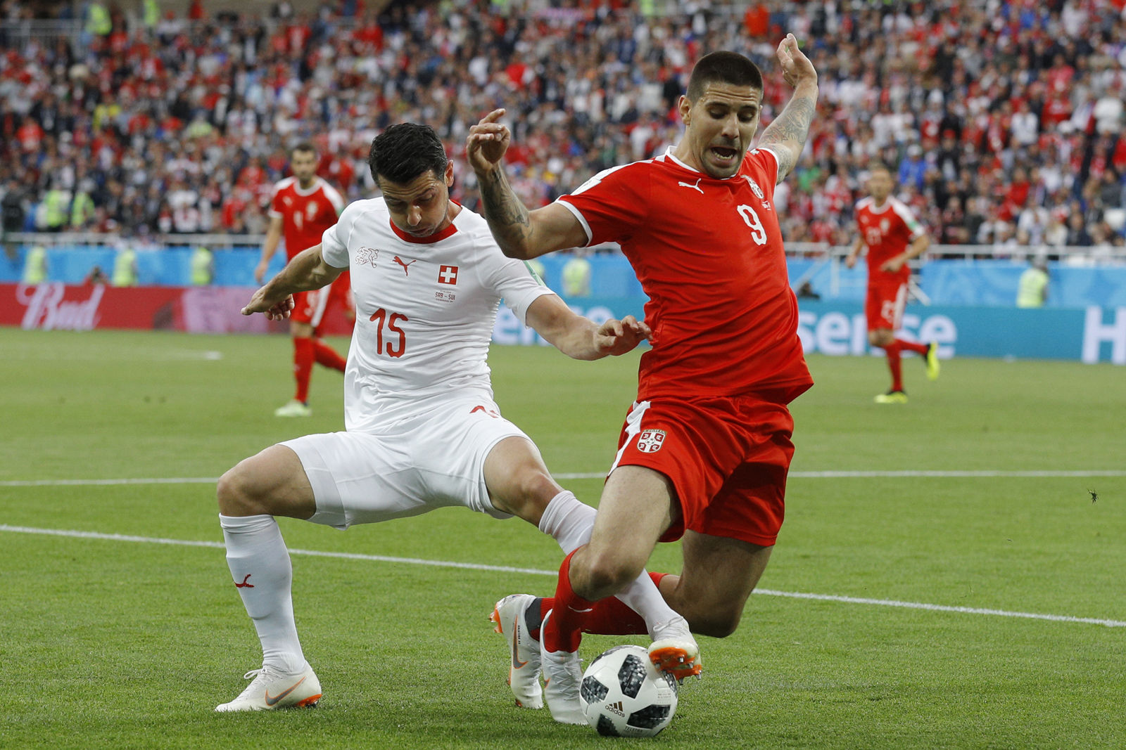 Switzerland's Blerim Dzemaili, left, and Serbia's Aleksandar Mitrovic battle for the ball during the group E match between Switzerland and Serbia at the 2018 soccer World Cup in the Kaliningrad Stadium in Kaliningrad, Russia, Friday, June 22, 2018. (AP Photo/Victor Caivano)