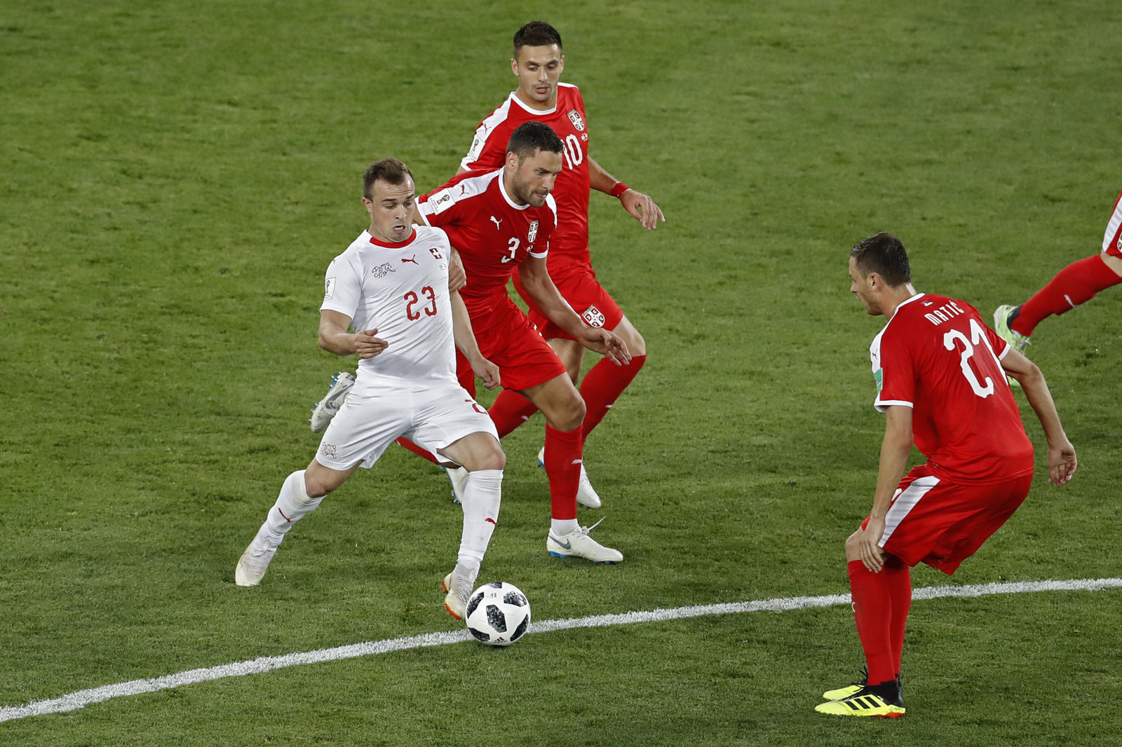 Switzerland's Xherdan Shaqiri, left, vies for the ball with Serbian defenders during the group E match between Switzerland and Serbia at the 2018 soccer World Cup in the Kaliningrad Stadium in Kaliningrad, Russia, Friday, June 22, 2018. (AP Photo/Antonio Calanni)