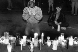 FILE - In this May 21, 1990 file picture, Scotty McQuown of San Francisco, left, weeps in front of a makeshift memorial to AIDS victims during the seventh annual International AIDS Candlelight Memorial in San Francisco. Up to 20,000 people gathered in front of San Francisco's City Halll to remember those lost to the disease and those still fighting it. Sunday, June 5, 2011 marks 30 years since the first AIDS cases were reported in the United States. Nearly 30 million people have died of AIDS since the first five cases were recognized in Los Angeles in 1981. About 34 million people have HIV now, including more than 1 million in the United States. (AP Photo/Bill Beattie)