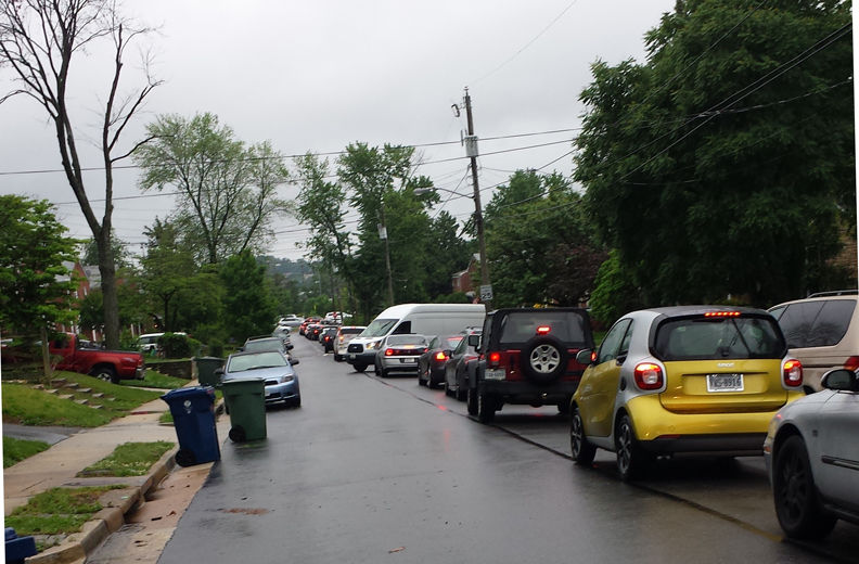 Traffic backs up on East Taylor Run Parkway on May 16, 2018. Drivers cutting through the street are known for blocking driveways, striking parked cars, cursing out residents and honking their horns in stopped traffic. Neighbors have been complaining to the Alexandria city officials for years, as well as to the police. (WTOP/Colleen Kelleher)