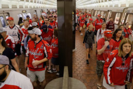 People wait on the platform to use the escalator as they begin to exit the National Archives Metro Subway station and head towards the Washington Capitals Stanley Cup victory parade on the National Mall in Washington, Tuesday, June 12, 2018. (AP Photo/Pablo Martinez Monsivais)