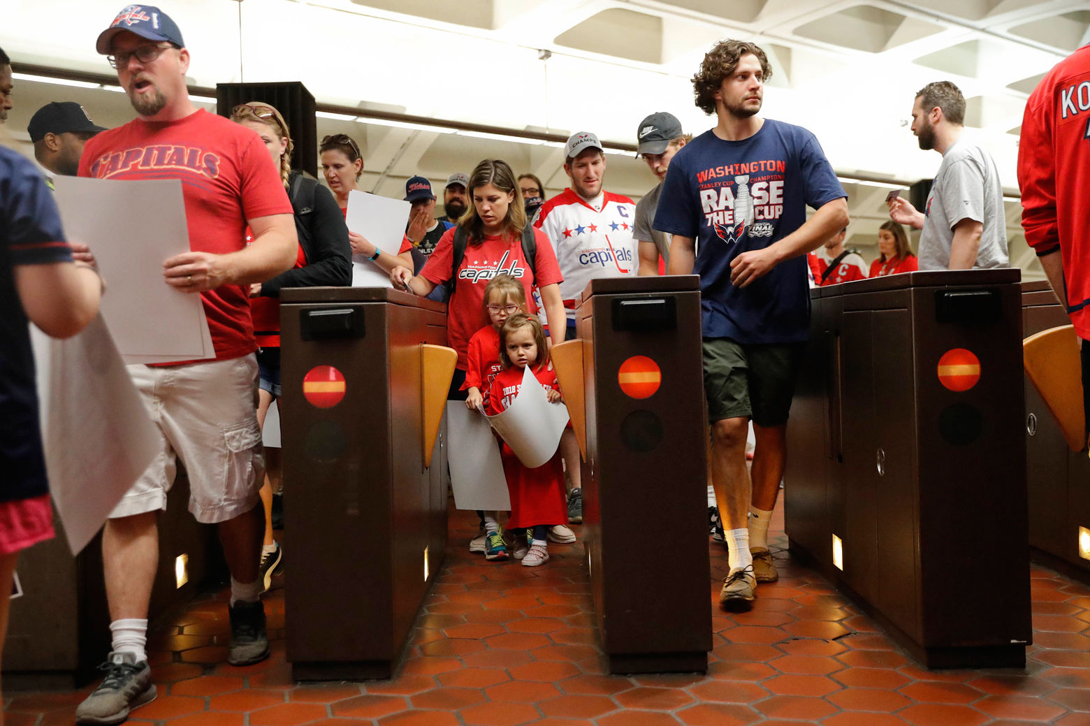 People use the turnstiles as they exit the National Archives Metro Subway station and head towards the Washington Capitals Stanley Cup victory parade on the National Mall in Washington, Tuesday, June 12, 2018. (AP Photo/Pablo Martinez Monsivais)