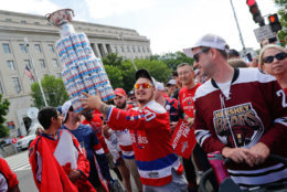 A fan carries a home-made Stanley Cup made of mostly empty beer cans as people begin to arrive for the Washington Capitals Stanley Cup victory parade on Constitution Ave., along the National Mall in Washington, Tuesday, June 12, 2018. (AP Photo/Pablo Martinez Monsivais)