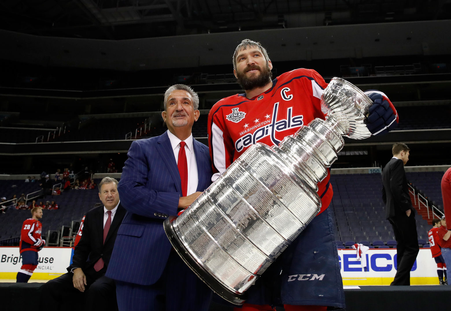 Washington Capitals NHL hockey team owner Ted Leonsis, left, and Washington Capitals left wing Alex Ovechkin, from Russia, pose for picture with the Stanley Cup on the ice at Capital One Arena, Tuesday, June 12, 2018, in Washington. 