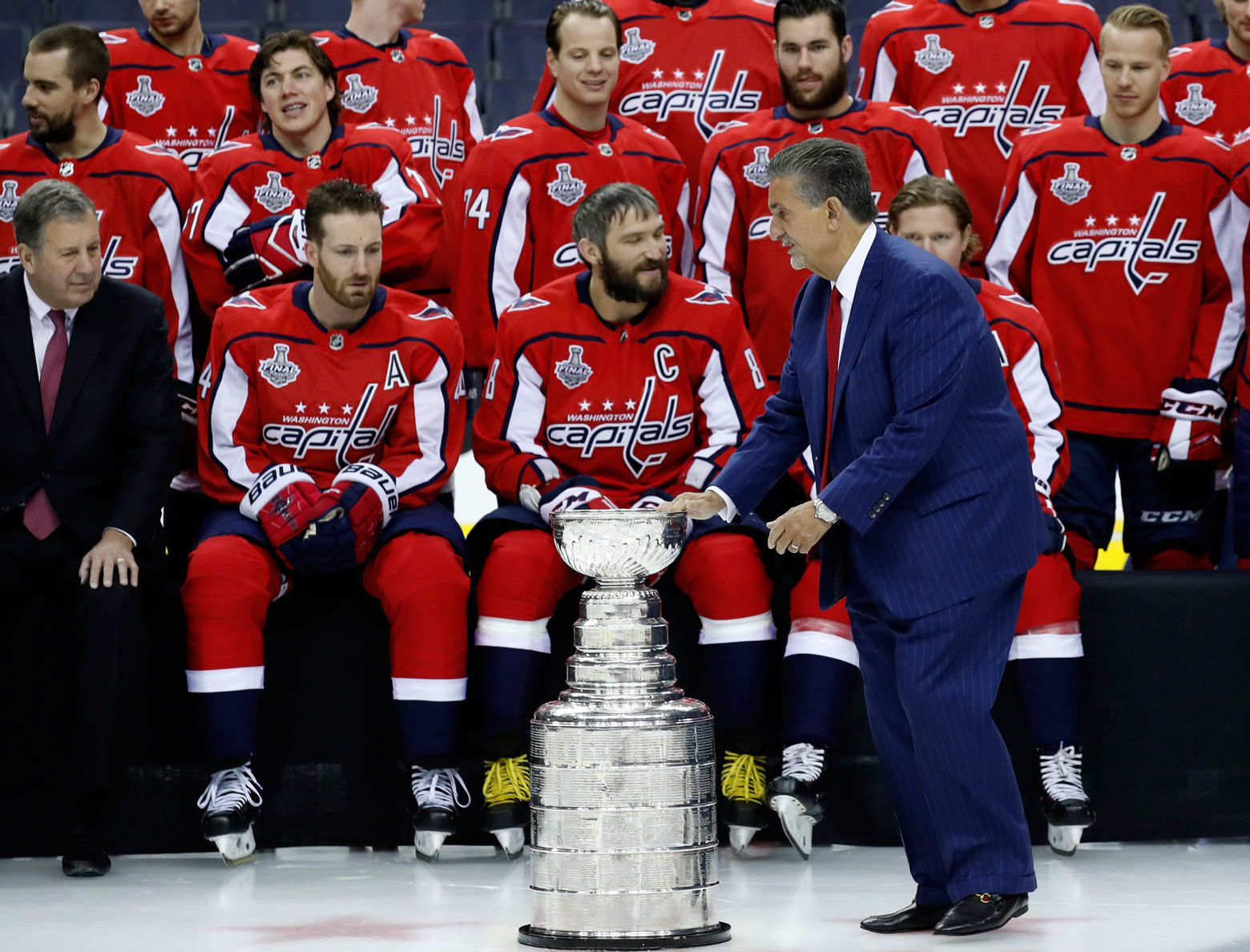 Ted Leonsis touches the Stanley Cup during the team picture with the Stanley Cup on the ice at Capital One Arena, Tuesday, June 12, 2018, in Washington. (AP Photo/Alex Brandon)