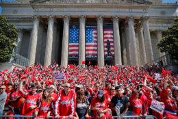 Fans gather on the steps of the National Archives Building as they wait to watch the Capitals parade along the National Mall. (AP Photo/Pablo Martinez Monsivais)
