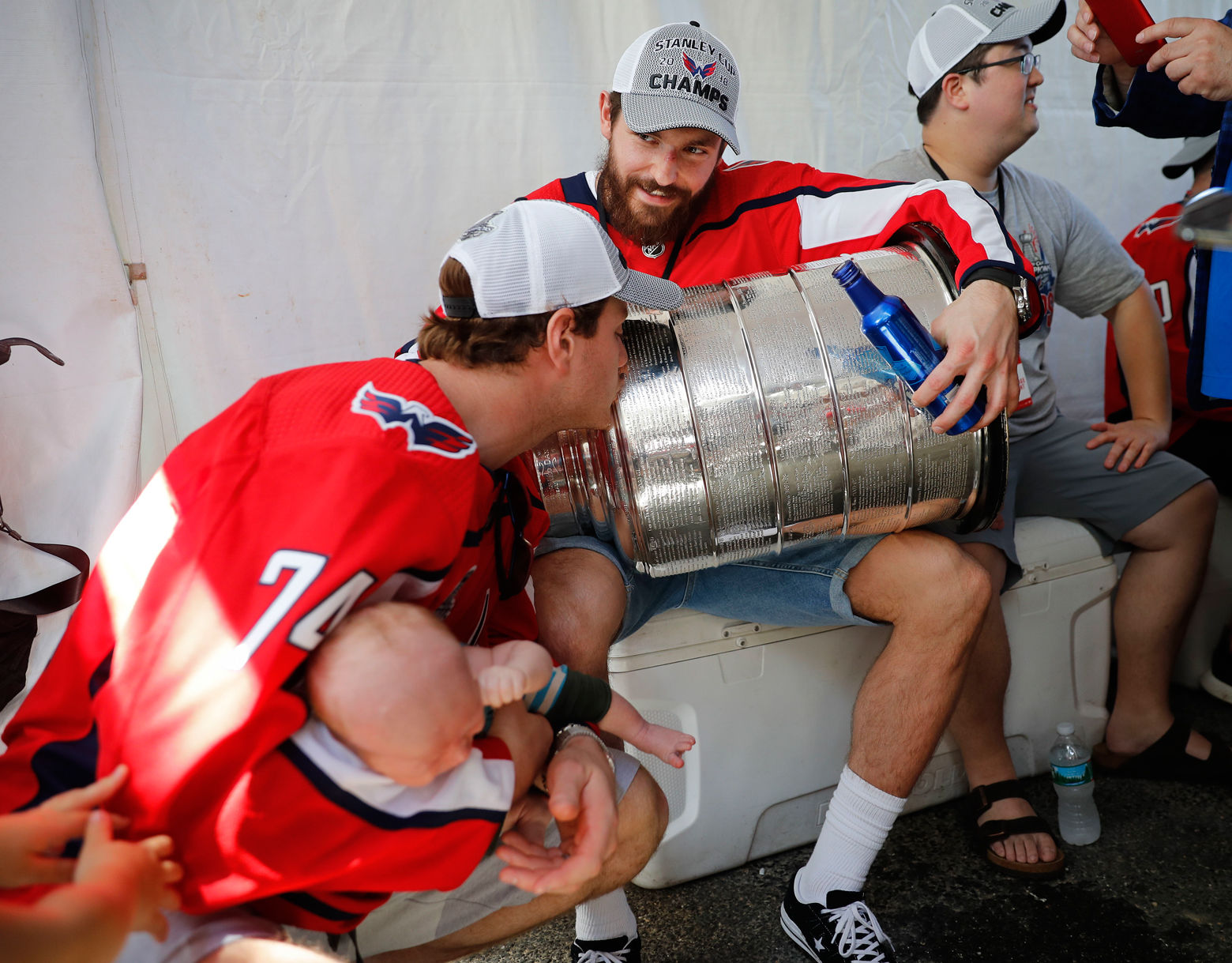 John Carlson (74), left, kisses the Stanley Cup held by teammate defenseman Michal Kempny (6), of the Czech Republic, as they wait to take the stage for the Stanley Cup victory celebration in Washington, Tuesday, June 12, 2018. (AP Photo/Pablo Martinez Monsivais)