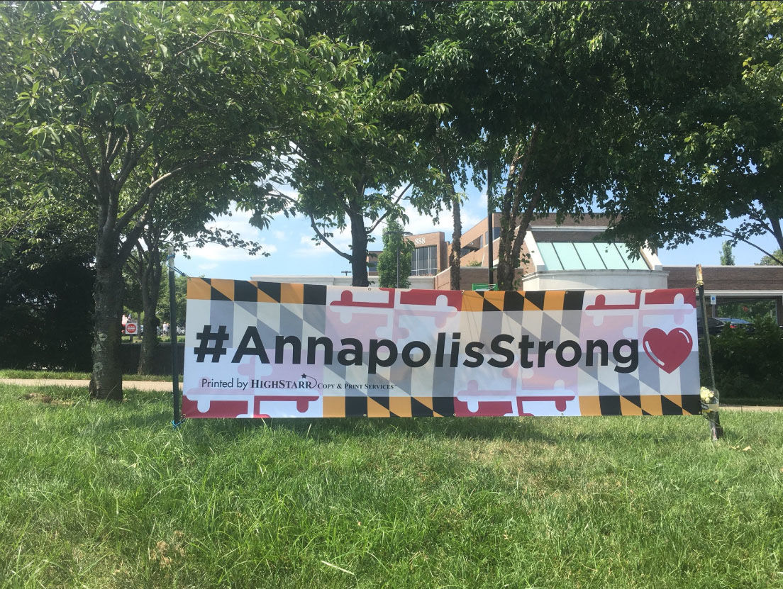 A sign stands near the Capital Gazette building where a shooting took place Thursday that killed five people. (WTOP/Mike Murillo)