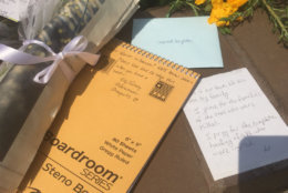 People leave messages of grief and support during a vigil on Friday, June 29, 2018, for the victims of the Capital Gazette shooting. (WTOP/Mike Murillo)