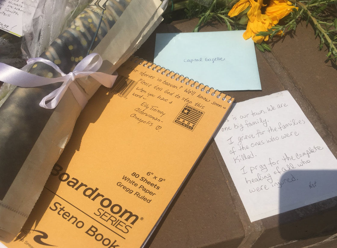 People leave messages of grief and support during a vigil on Friday, June 29, 2018, for the victims of the Capital Gazette shooting. (WTOP/Mike Murillo)
