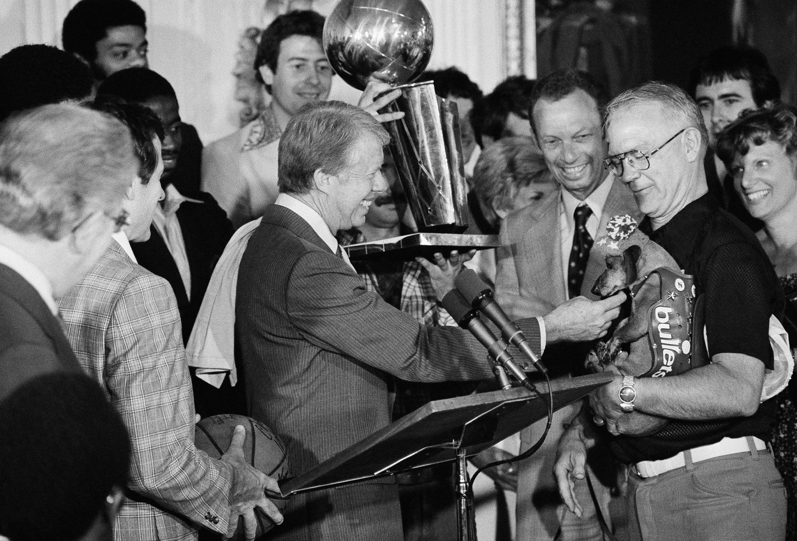 President Carter greets "Tiny," the mascot of NBA champions the Washington Bullets, during a reception for the team and supporters at the White House in Washington on June 10, 1978. (AP Photo/Barry Thumma)
