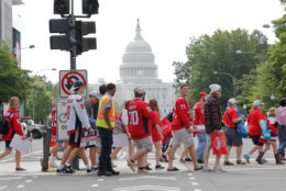 Fans cross Pennsylvania Ave., as they head towards the Washington Capitals Stanley Cup victory parade route on the National Mall in Washington, Tuesday, June 12, 2018. (AP Photo/Pablo Martinez Monsivais)