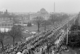 Thousands of Washington Redskins fans line Constitution Avenue in preparation for a parade in honor of the champions of Super Bowl XVII, Feb. 2, 1983. A constant downpour failed to dampen the spirits of the crowd, which stood in the rain for two hours for their football heroes. (AP Photo/Ira Schwarz)